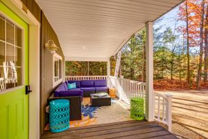 a porch with a purple couch on a deck at Sip and Hike! Autumn Escape 12 Mi to Traverse City in Grawn