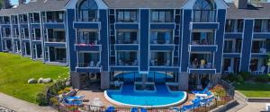 an aerial view of a large blue building with a swimming pool at 108 Edgewater Inn in Charlevoix