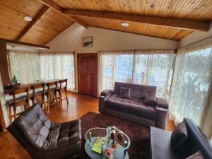 a living room with a couch and a table at cabañas Arcoíris del lago Nº 5 in Pasto