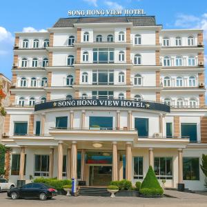 a large hotel with a car parked in front of it at SONG HONG VIEW HOTEL in Lao Cai