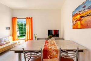 a dining room with a table and a couch at Departamentos Brown -WiFi 100 MB - Cochera - Parrilla - Aire - TV Cable in San Rafael
