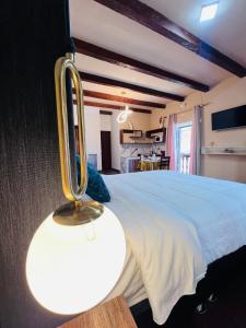 a bedroom with a bed with a light on it at Aristobilo Aloft- Matrimonial 2 in Chachapoyas