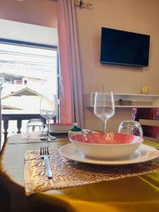 a table with a bowl of food and wine glasses at Aristobilo Aloft- Matrimonial 2 in Chachapoyas