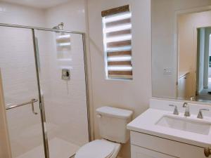 a bathroom with a toilet and a shower and a sink at Private suite downstairs in Irvine