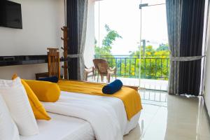 a bedroom with a bed with a view of a balcony at Hotel Mississipi Ella in Ella