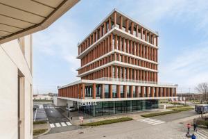 an office building with a tall building at Harbour View 2A in Zeebrugge