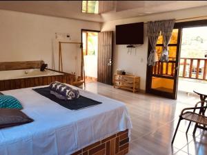 a bedroom with a bed and a television in it at K a p l a A l o j a m i e n t o in San Rafael