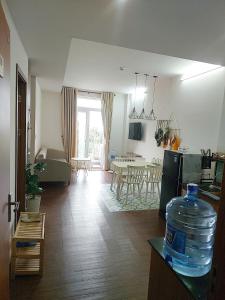 a kitchen and living room with a bottle of water on a counter at DINO Home HACOM 2BR city center in Kinh Dinh +8 photos