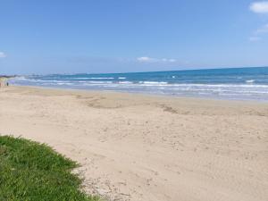 a sandy beach with the ocean in the background at Sognare sul mare in Granelli +6 photos