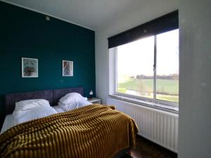 a bedroom with a bed and a large window at Le Beau Souvenir, Noiseux in Noiseux