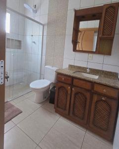 a bathroom with a toilet and a sink and a shower at Recanto do Sossego in Barra Velha