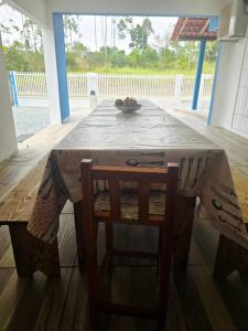 a table and a chair with a table and a table at Recanto do Sossego in Barra Velha