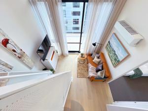 an overhead view of a living room with white curtains at Convenient Loft Modern Stay Central Box Hill in Box Hill