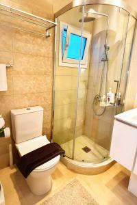 a bathroom with a shower and a toilet and a sink at sea soul house in Athens