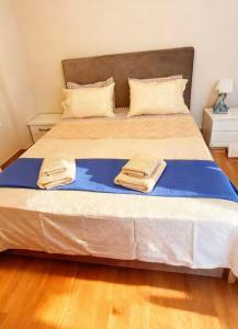 a large bed with two towels on top of it at sea soul house in Athens