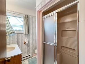a bathroom with a sink and a refrigerator at Sandcastle in Wells +23 photos