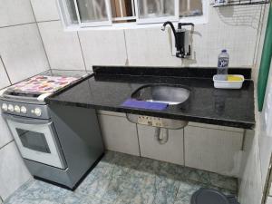 a small kitchen with a sink and a stove at Ct galo confins in Vespasiano +6 photos