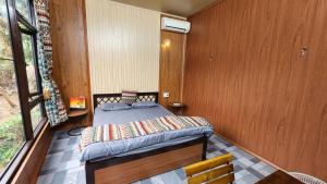 a small bedroom with a bed in a house at Thac so 6 homestay in Ha Giang +3 photos