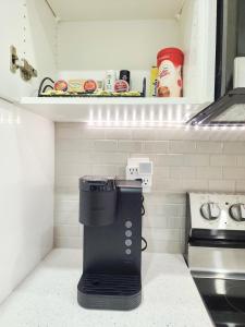 a kitchen with a coffee maker on a counter at A true Home away from Home in Calgary +24 photos