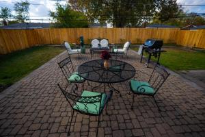 a patio with a table and chairs and a table and chairs at Charming Getaway Make Memories in Sterling Heights