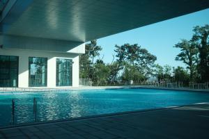 a swimming pool in front of a building at Seohaemaroo Youthhostel in Hwaseong