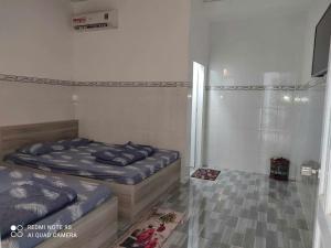 una camera da letto con due letti e una finestra di Thiên Thanh Long Hải Motel a Long Hai Altre 13 foto