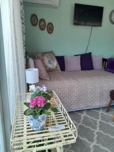 a living room with a couch and a table with flowers on it at BnB on Bakers in Waimate