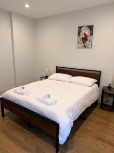 a bedroom with a large bed with white sheets at Boston Historic Lower Mills in Boston