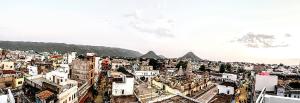 an aerial view of a city with mountains in the background at Hotel Ajanta in Pushkar +18 photos