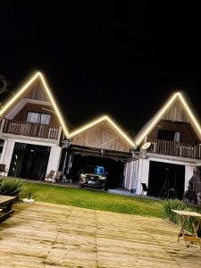 a house with lights on it at night at Chalé na beira da lagoa com vista in Imbituba