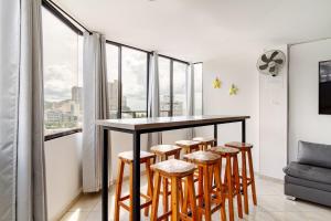 - un bar avec tabourets dans une pièce dotée de fenêtres dans l'établissement Rodadero Sol & Mar, à Gaira