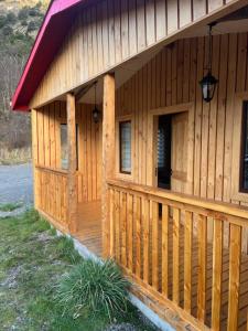 a large wooden building with a porch and a porch at Cabañas - Casa Rural 32 in Villa O'Higgins