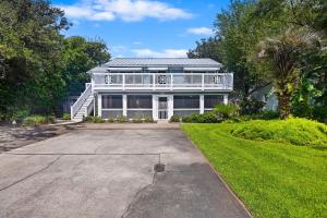 a large white house with a porch at CA411: 411 Carolina Blvd. in Isle of Palms