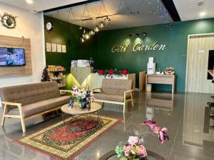 a store with two couches and a table in a room at Collection O Malacca Near St John's Fort Formerly Gill Garden in Melaka