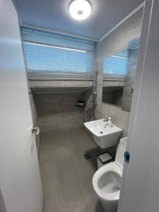 a bathroom with a toilet and a sink at 뚠하우스3 in Samgong +18 photos