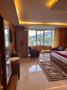 a large living room with a bed and a couch at Hotel North Hill in Tawang