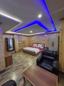 a bedroom with a bed and a blue ceiling at Hotel North Hill in Tawang