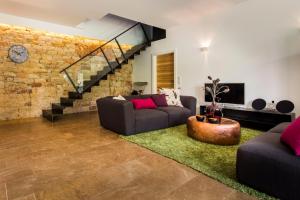 a living room with two couches and a brick wall at Loblocher Hof in Neustadt an der Weinstraße