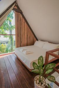 a bed in a room with a large window at THE LOFT - Super Central General Luna in General Luna
