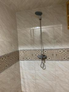 a shower with a shower head in a bathroom at Dar Nassiri in Rabat