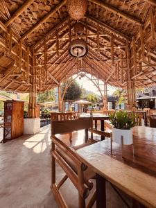 a large wooden pavilion with tables and benches at Cicada Lanta in Ko Lanta