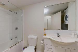 a bathroom with a sink and a toilet and a mirror at Sweet Mango Hill Apartment w Convenient Location in North Lakes +6 photos