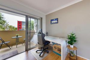 an office with a desk and a chair and a balcony at Sweet Mango Hill Apartment w Convenient Location in North Lakes
