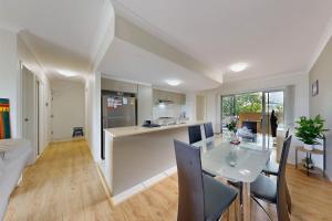a kitchen and dining room with a table and chairs at Sweet Mango Hill Apartment w Convenient Location in North Lakes