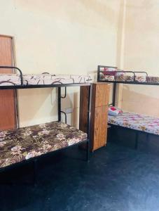 a room with three bunk beds in it at Negombo hostel in Negombo