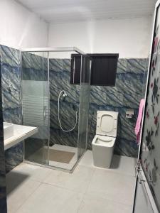 a bathroom with a shower and a toilet at Negombo hostel in Negombo