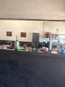 a kitchen with a counter top with items on it at Negombo hostel in Negombo