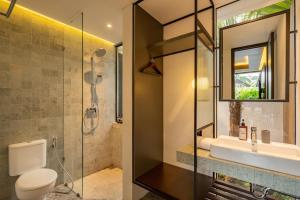 a bathroom with a shower and a toilet and a sink at Lovely 3 Bedroom Villa in Ubud - Artha Loka OA in Ubud +14 photos