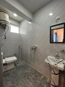 a bathroom with a shower and a toilet and a sink at Begonia Homestay Darjeeling in Darjeeling