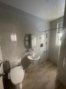 Un baño con inodoro, lavabo y ducha. en Xing Yu Hotel, en Mao-i-san-ts'un